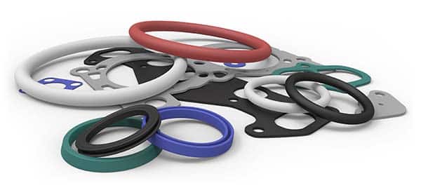 Blue, green, gray, red, and black gaskets and seals in a pile