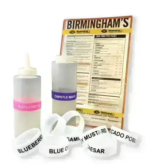 Menu board with sauce bottles and assorted custom label bands.